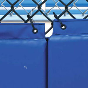 Backstop Padding with grommets attached to a baseball field fence